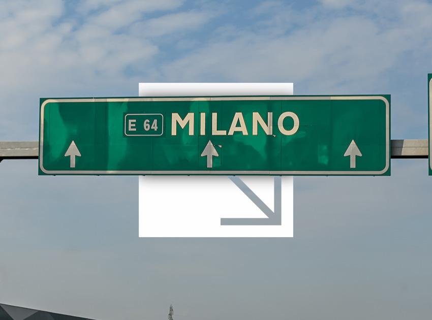 Road sign for Milano on the E64 motorway, useful for tourists travelling with car hire excess insurance in Italy.