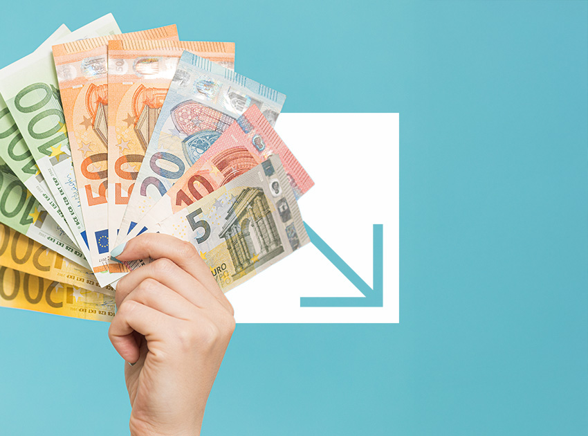 Hand fanning out multiple euro banknotes, representing travel costs alongside the value of car hire excess insurance.